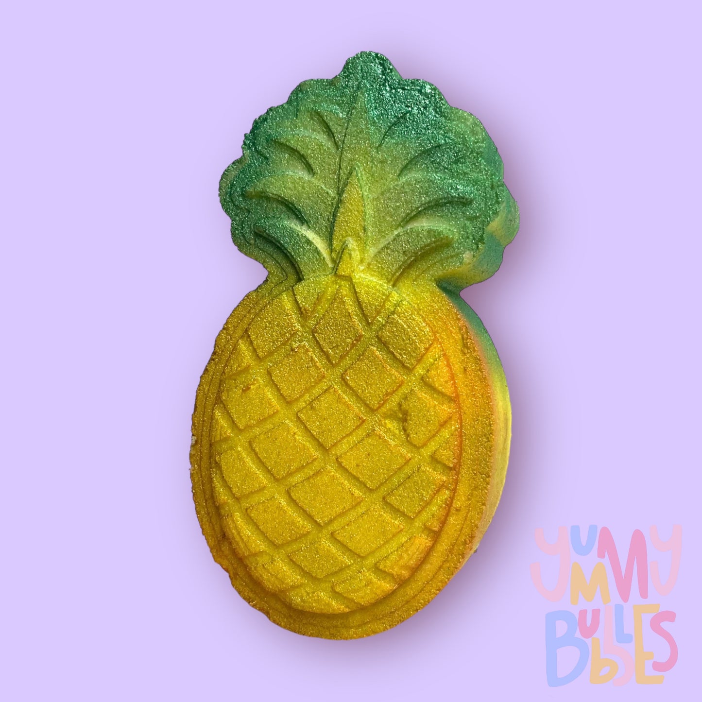 yellow pineapple shaped bath bomb with a green painted stem