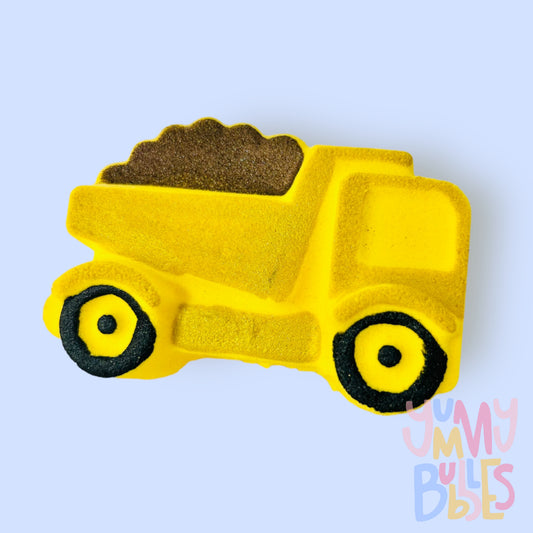 Yellow dump truck shaped bath bomb painted with yellow, black, and brown