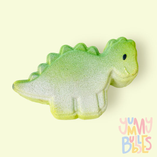 Green dino shaped bath bomb painted with a green to white gradient and a black eye