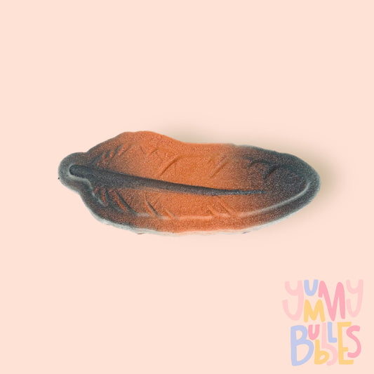 Feather shaped bath bomb painted with a black and orange gradient