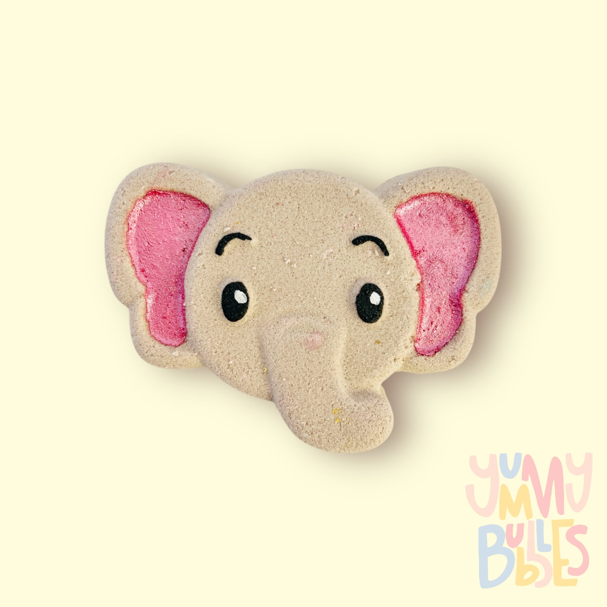 Grey elephant shaped bath bomb painted with light pink, black, and white