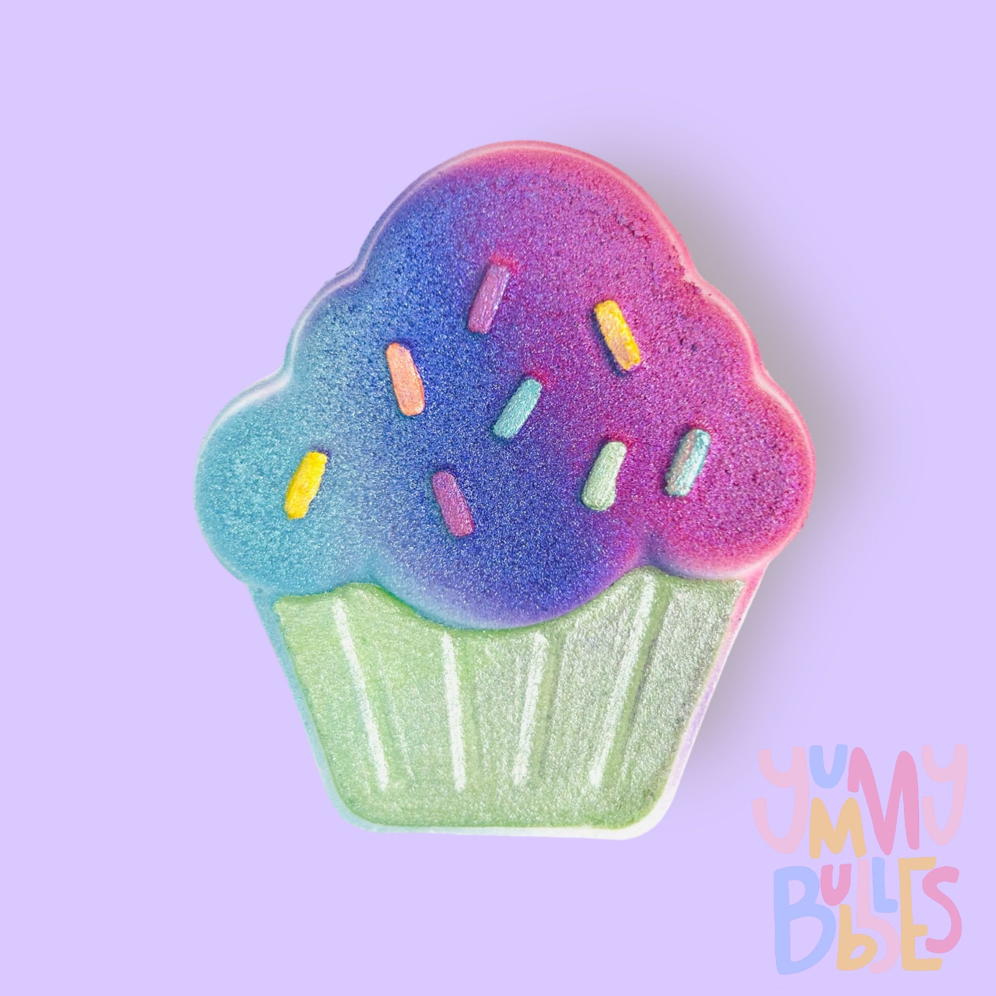 Cupcake shaped bath bomb painted with teal, blue, light green, and pink pastels