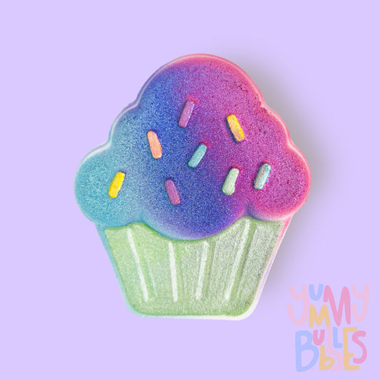 Cupcake shaped bath bomb painted with teal, blue, light green, and pink pastels