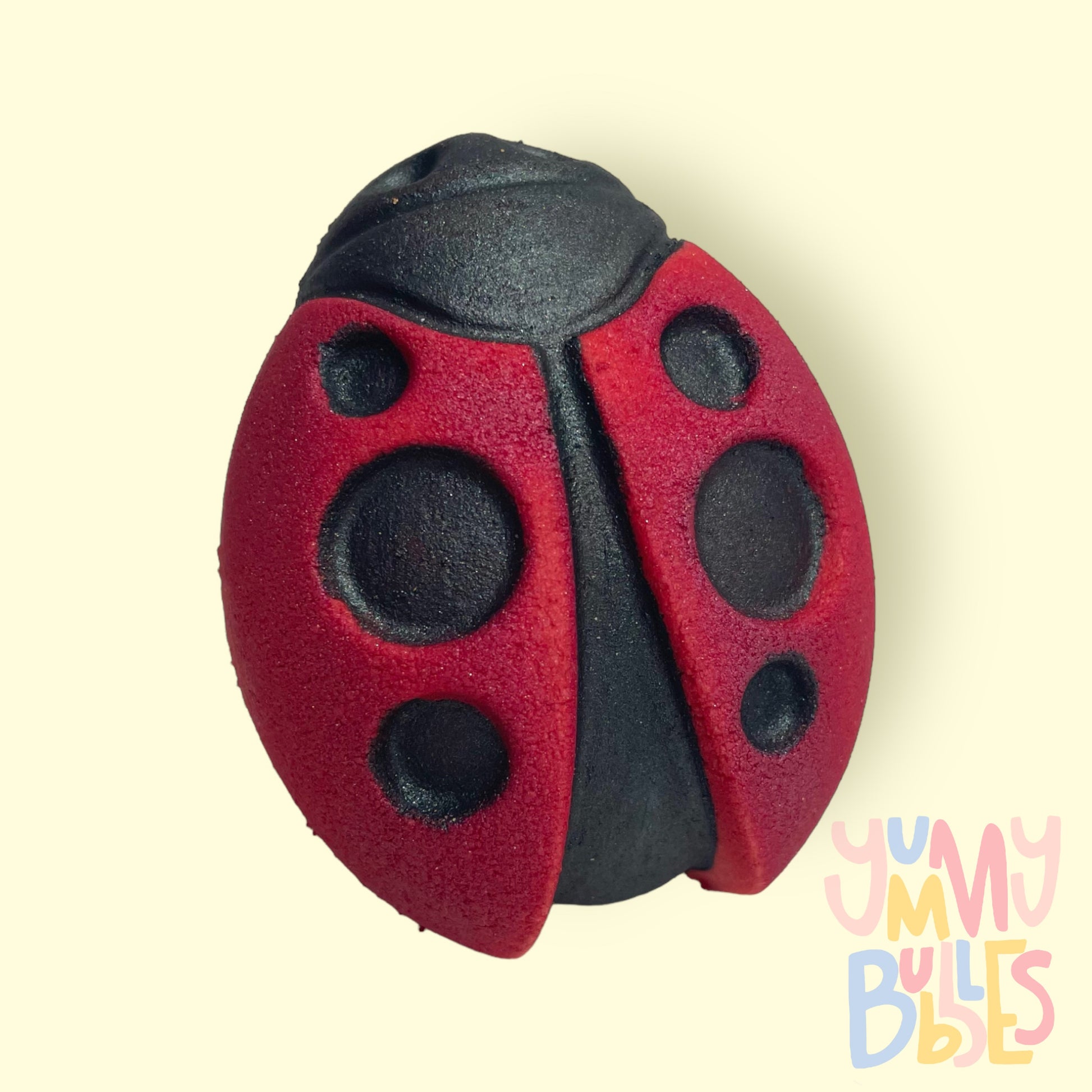 Red ladybug shaped bath bomb painted with black