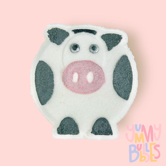 White cow shaped bath bomb with pink, white, and black paint