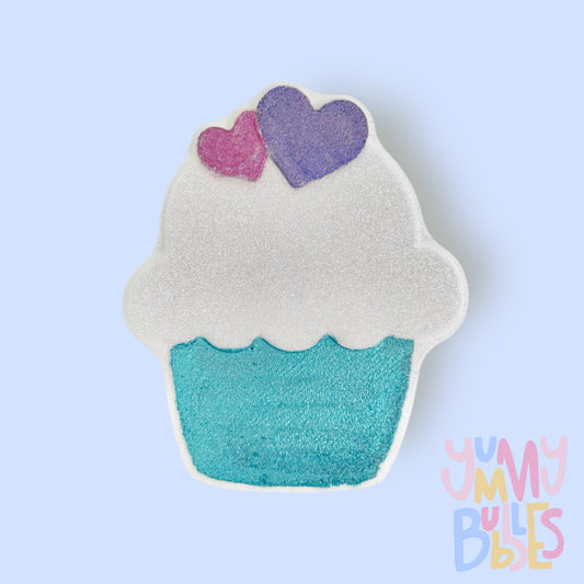 white cupcake shaped bath bomb painted with white, blue, pink, and purple