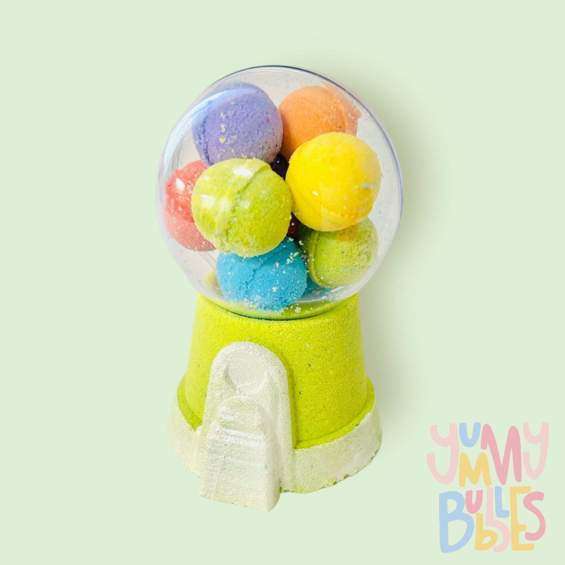 Green gumball machine bath bomb painted with white. Contains a plastic ball on top with a variety of different colored bath bomb gumballs.