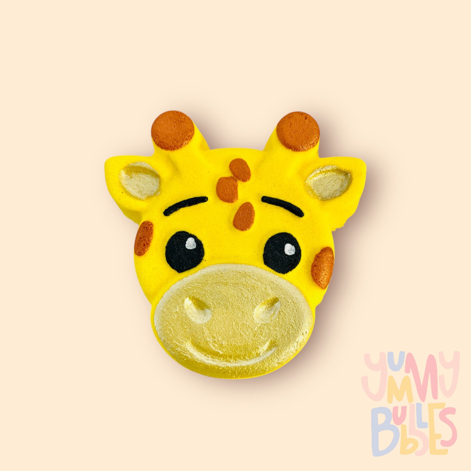yellow giraffe shaped bath bomb painted with orange, light yellow, black, and white