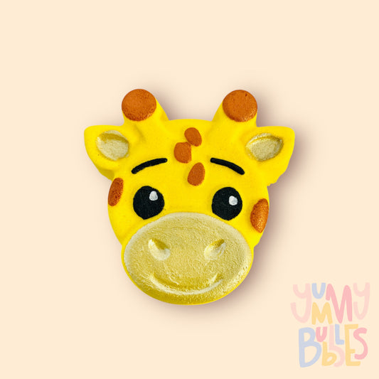 yellow giraffe shaped bath bomb painted with orange, light yellow, black, and white