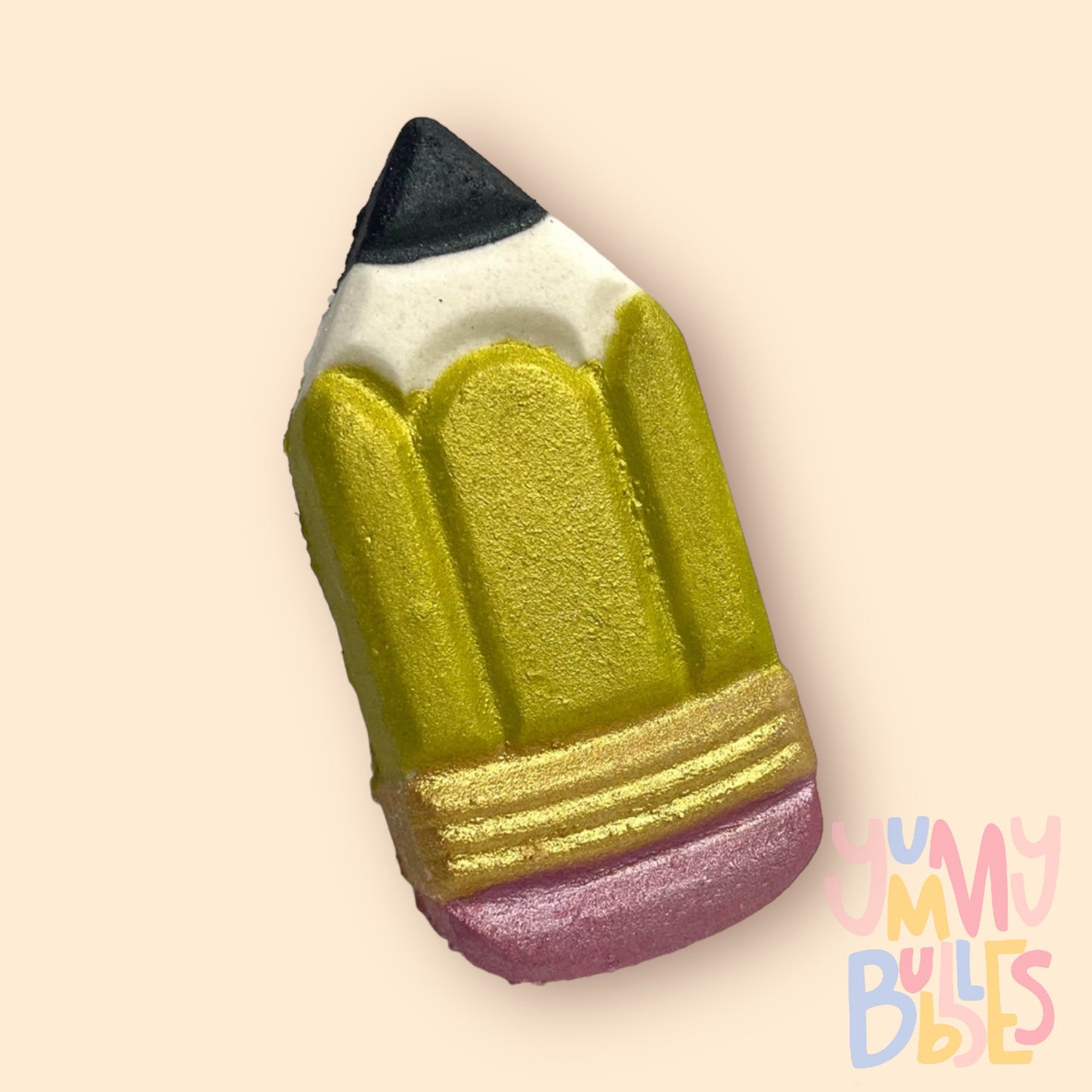 Pencil shaped bath bomb painted with yellow, gold, light pink, and black