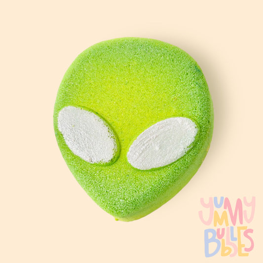 Green alien shaped bath bomb with white eyes