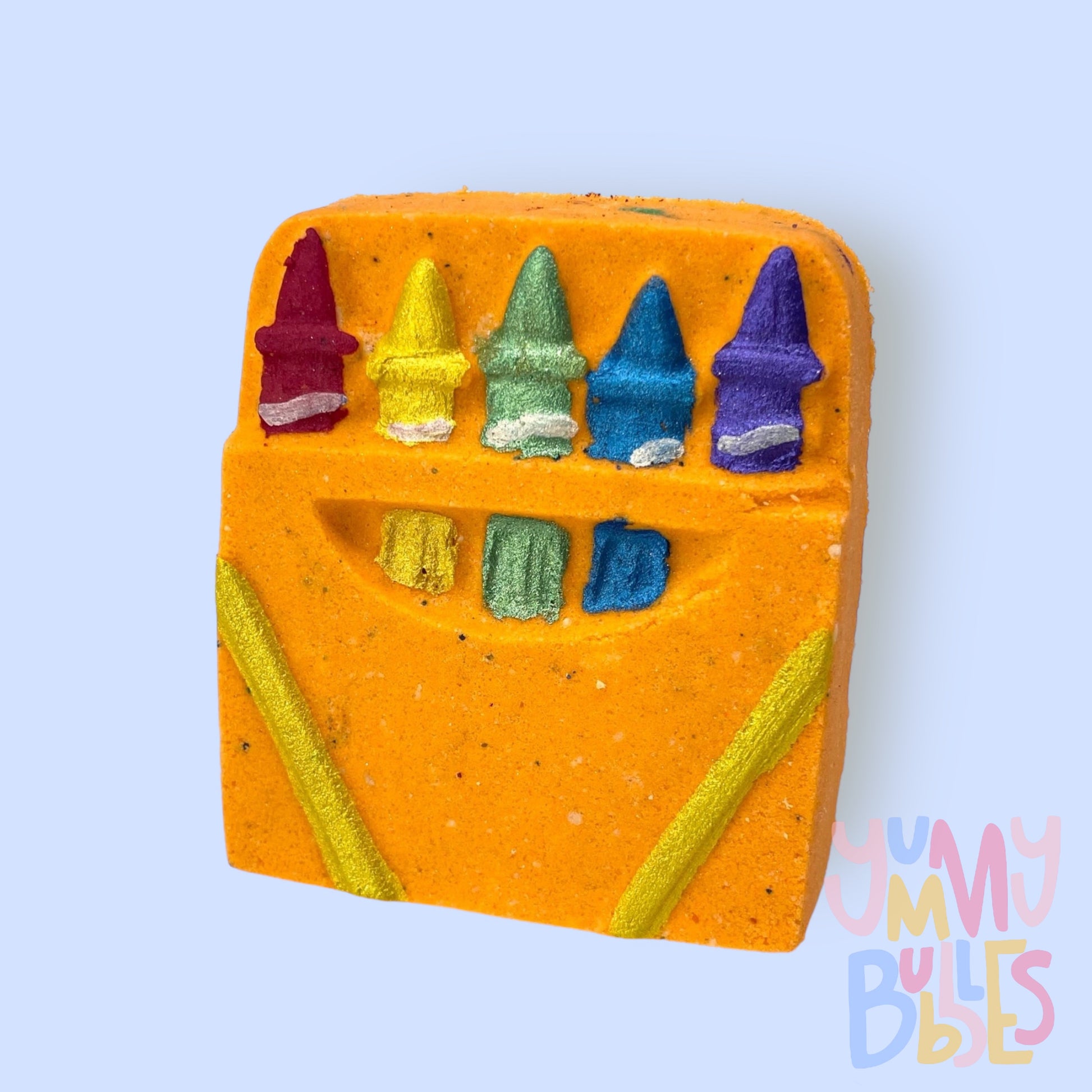 Orange crayon box shaped bath bomb with red, yellow, green, blue, and purple paint