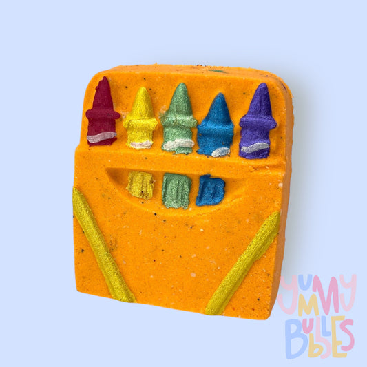 Orange crayon box shaped bath bomb with red, yellow, green, blue, and purple paint