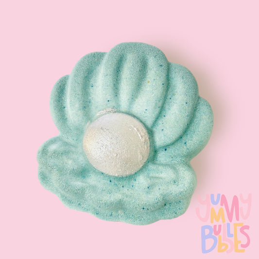 Teal clam shaped bath bomb with white painted pearl in the center