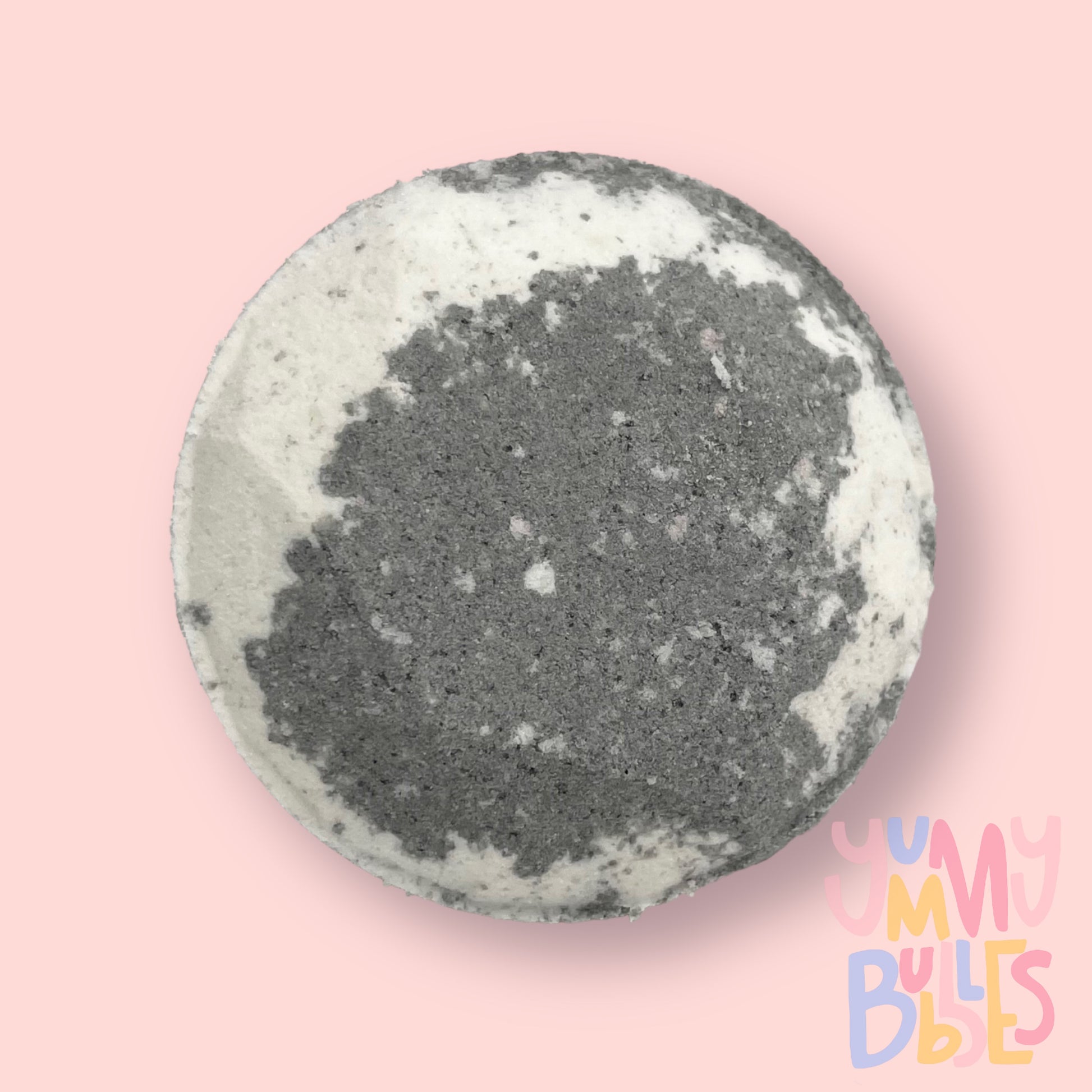 Circular shaped shower bomb colored with black and white