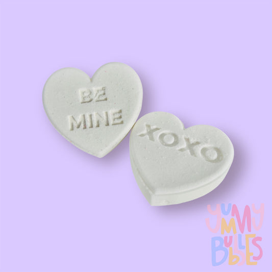 white candy gram shaped bath bomb with sweet messages such as xoxo, be mine, etc