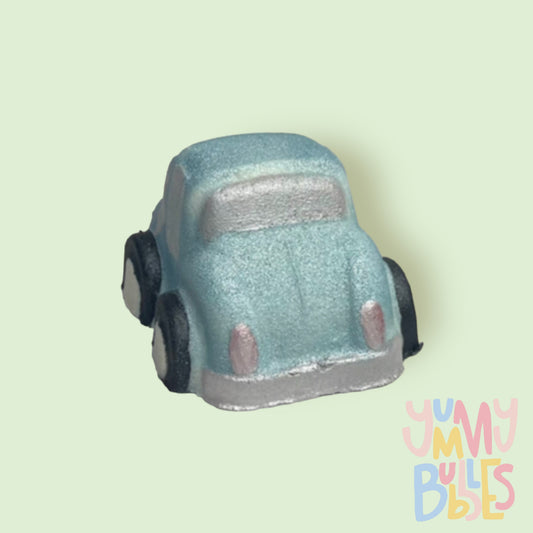 car shaped bath bomb painted light blue, white, and black