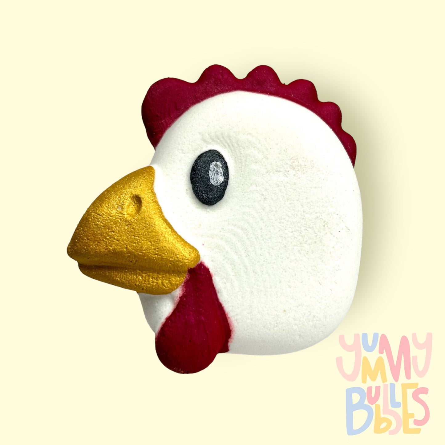 White chicken shaped chicken with red, yellow, black, and white paint