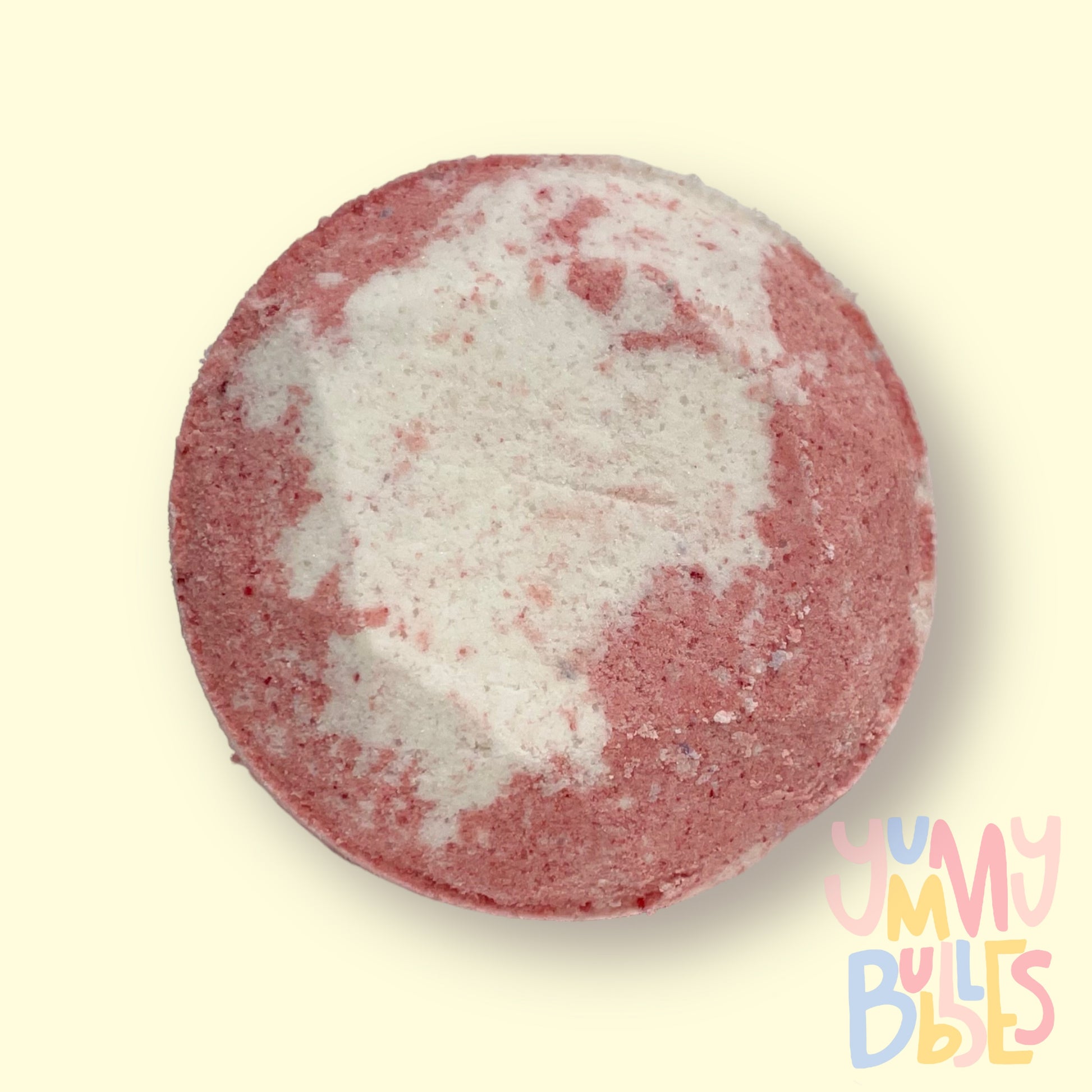 Circular shaped shower bomb colored with light red and white