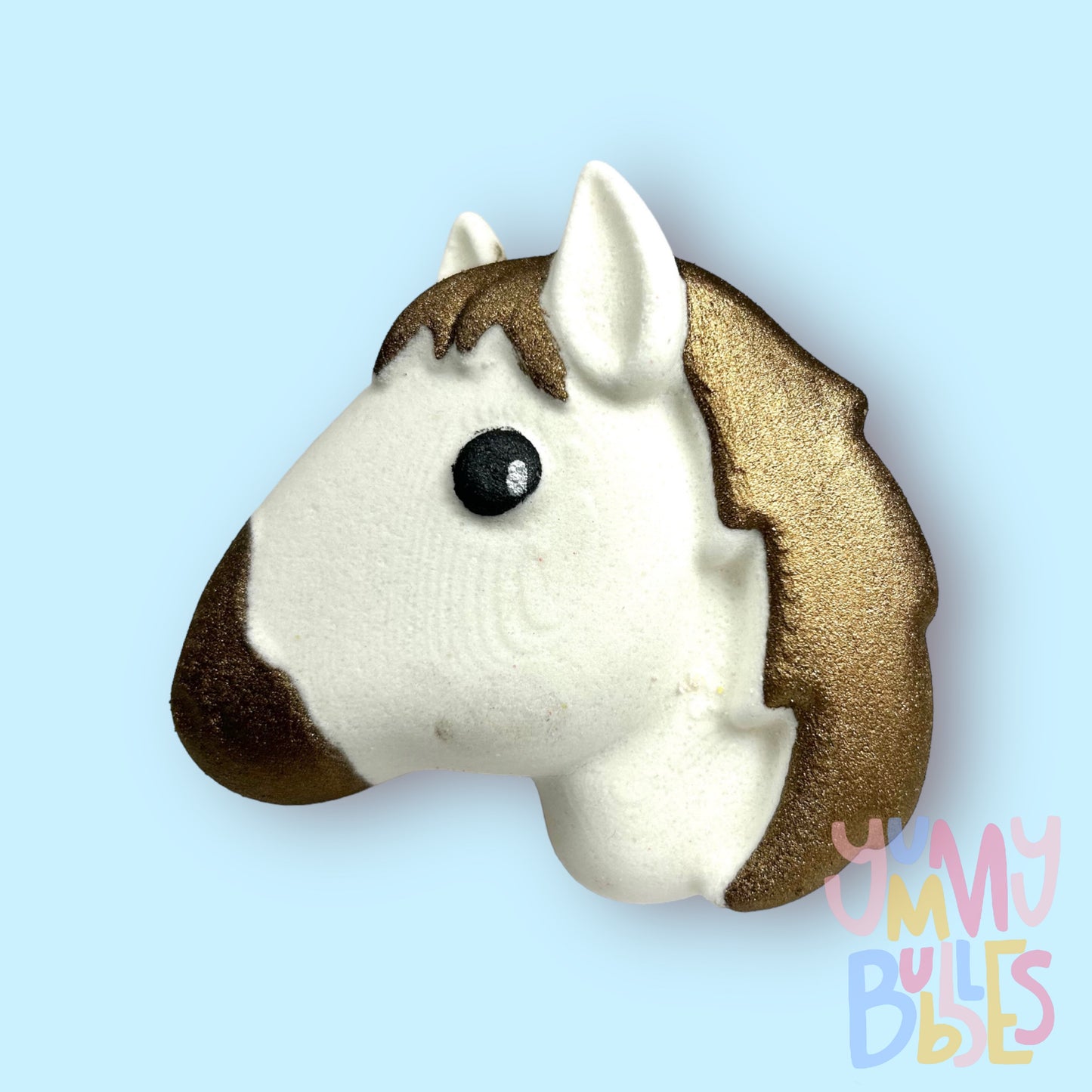 White horse head shaped bath bomb painted with brown, white, and black
