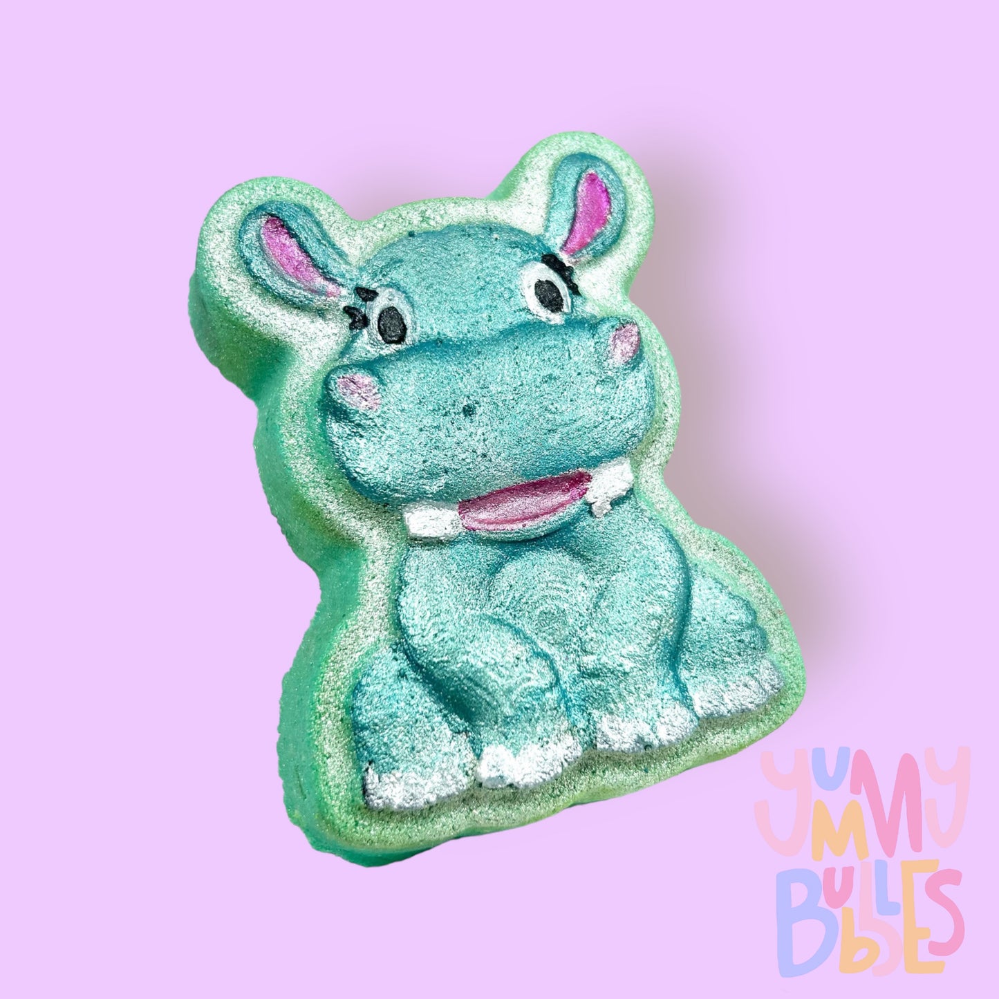 Teal hippo shaped bath bomb painted with teal, light pink, white, and black