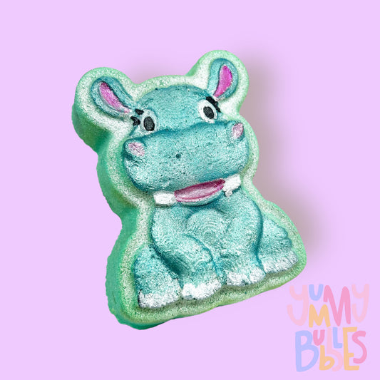 Teal hippo shaped bath bomb painted with teal, light pink, white, and black