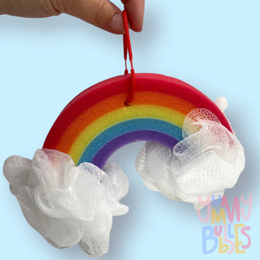 rainbow shaped sponge with fluffy cloud loofahs on each side. Rainbow sponge consists of red, orange, yellow, blue, and purple.