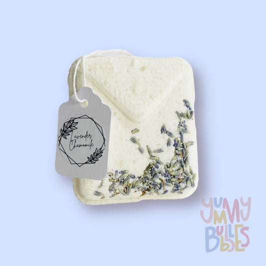 White tea bag shaped bath bomb with lavender embedded on top