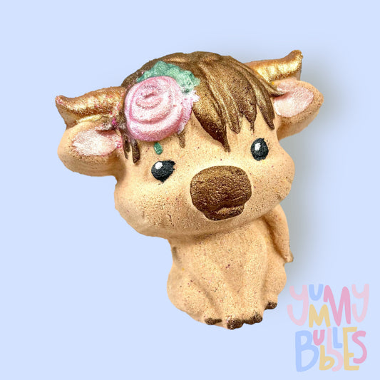 Brown highland cow shaped bath bomb with flower in hair, painted with light pink, light green, dark brown, black, and white