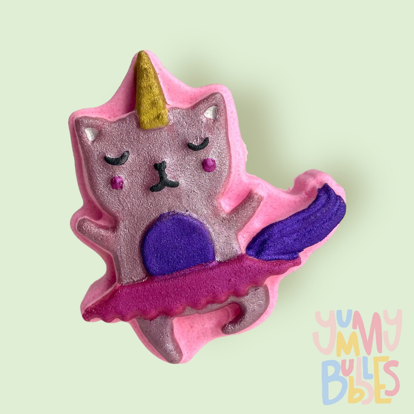 Pink Kitty ballerina shaped bath bomb painted with light and dark pink, purple, gold, white, and black