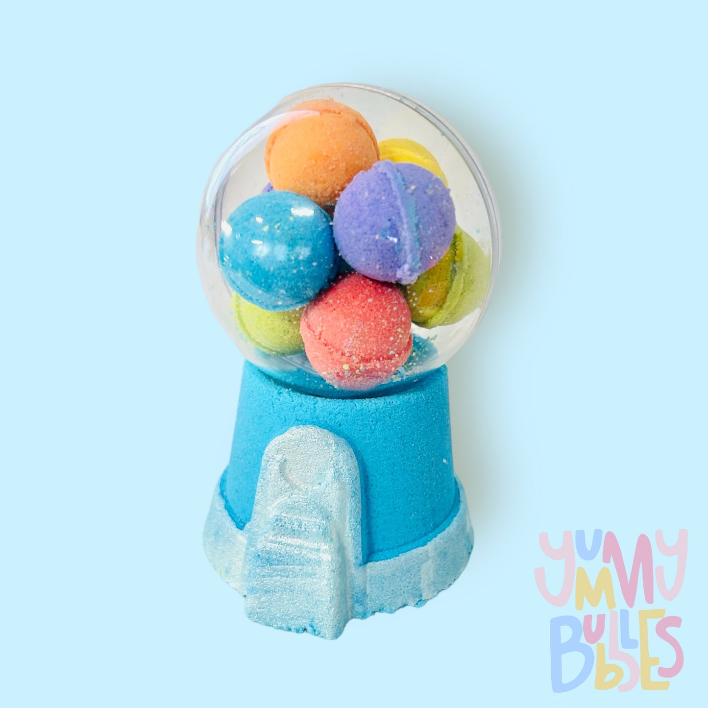 Blue gumball machine bath bomb painted with white. Contains a plastic ball on top with a variety of different colored bath bomb gumballs.