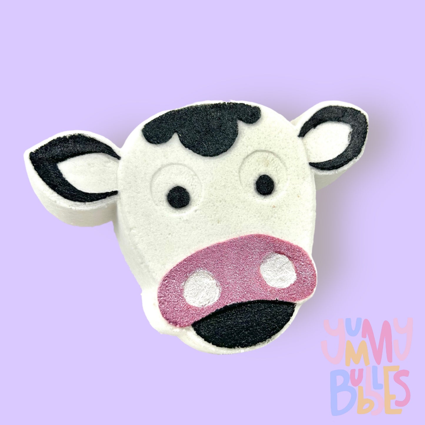 White cow shaped bath bomb with black and light pink paint