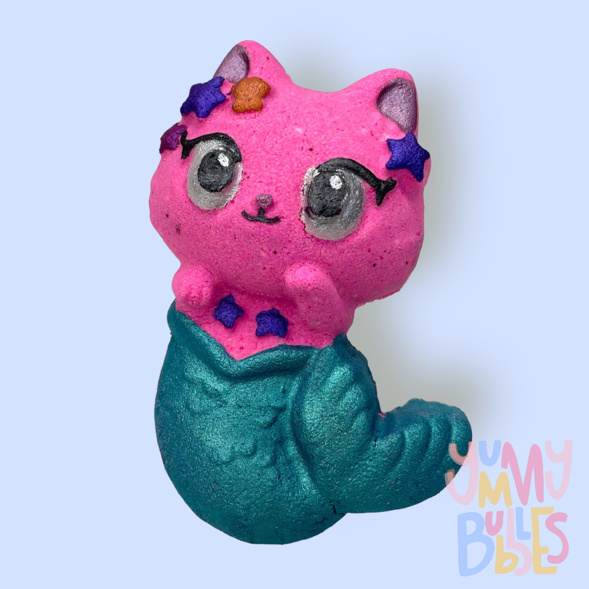 Pink mermaid cat shaped bath bomb painted with teal, purple, orange, white, light pink, and black