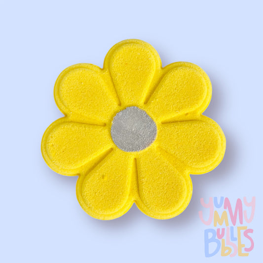 Yellow daisy shaped bath bomb with a white painted center