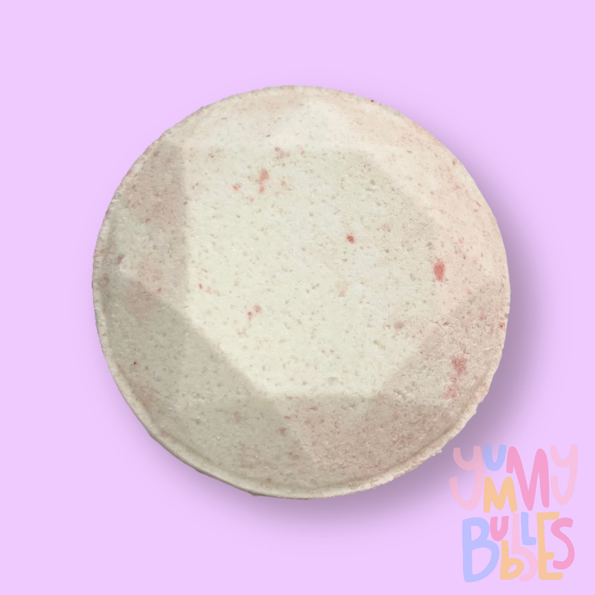 Circular shaped shower bomb colored with light pink and white
