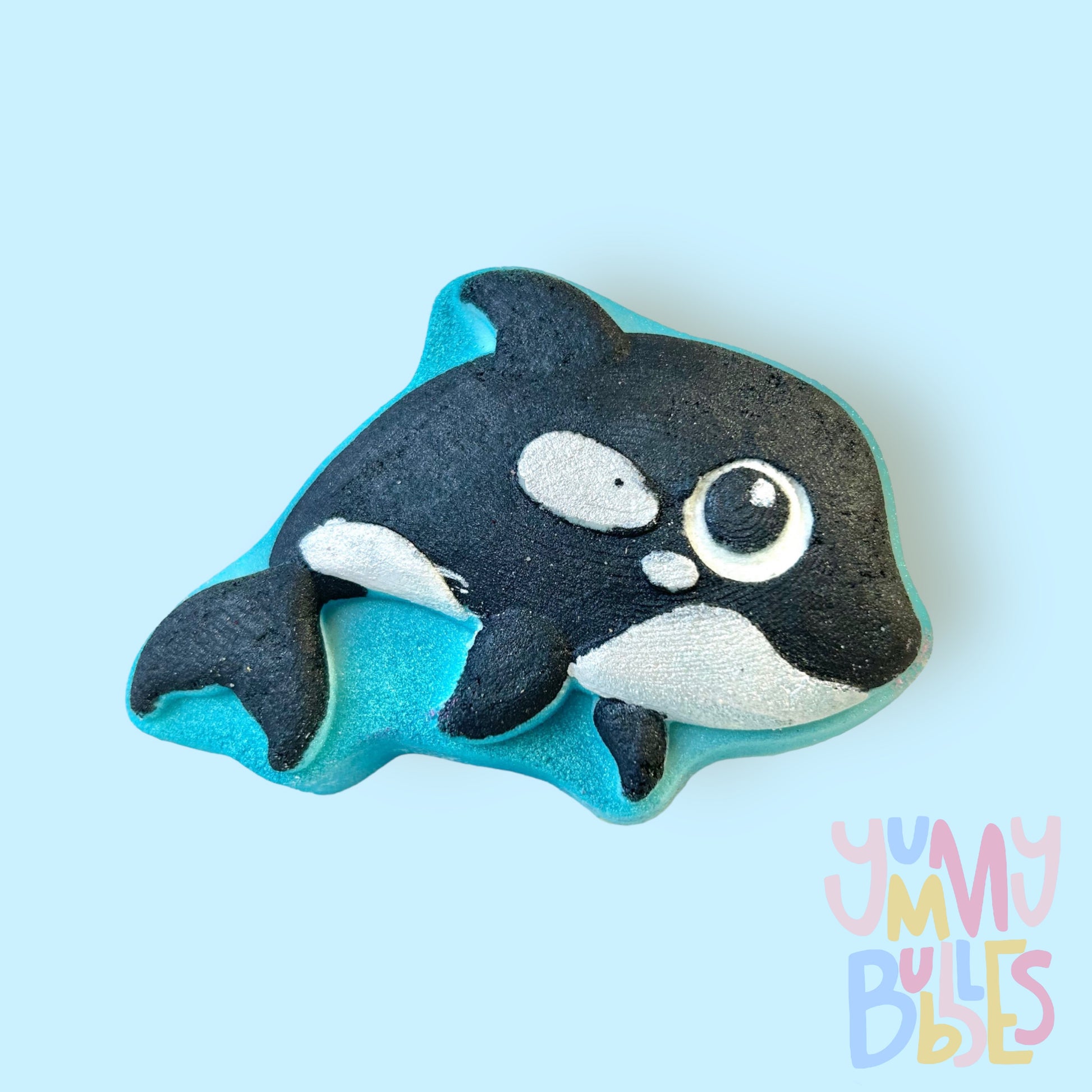 Orca shaped bath bomb with a blue base, painted with black and white
