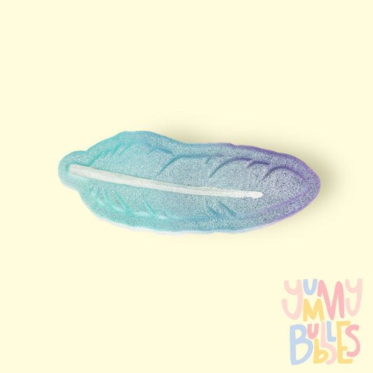 Feather shaped bath bomb painted with a blue to purple gradient and a white center