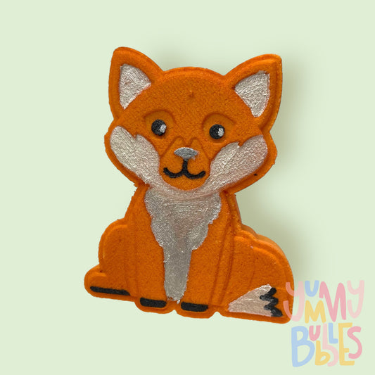 Orange fox shaped bath bomb painted with black and white