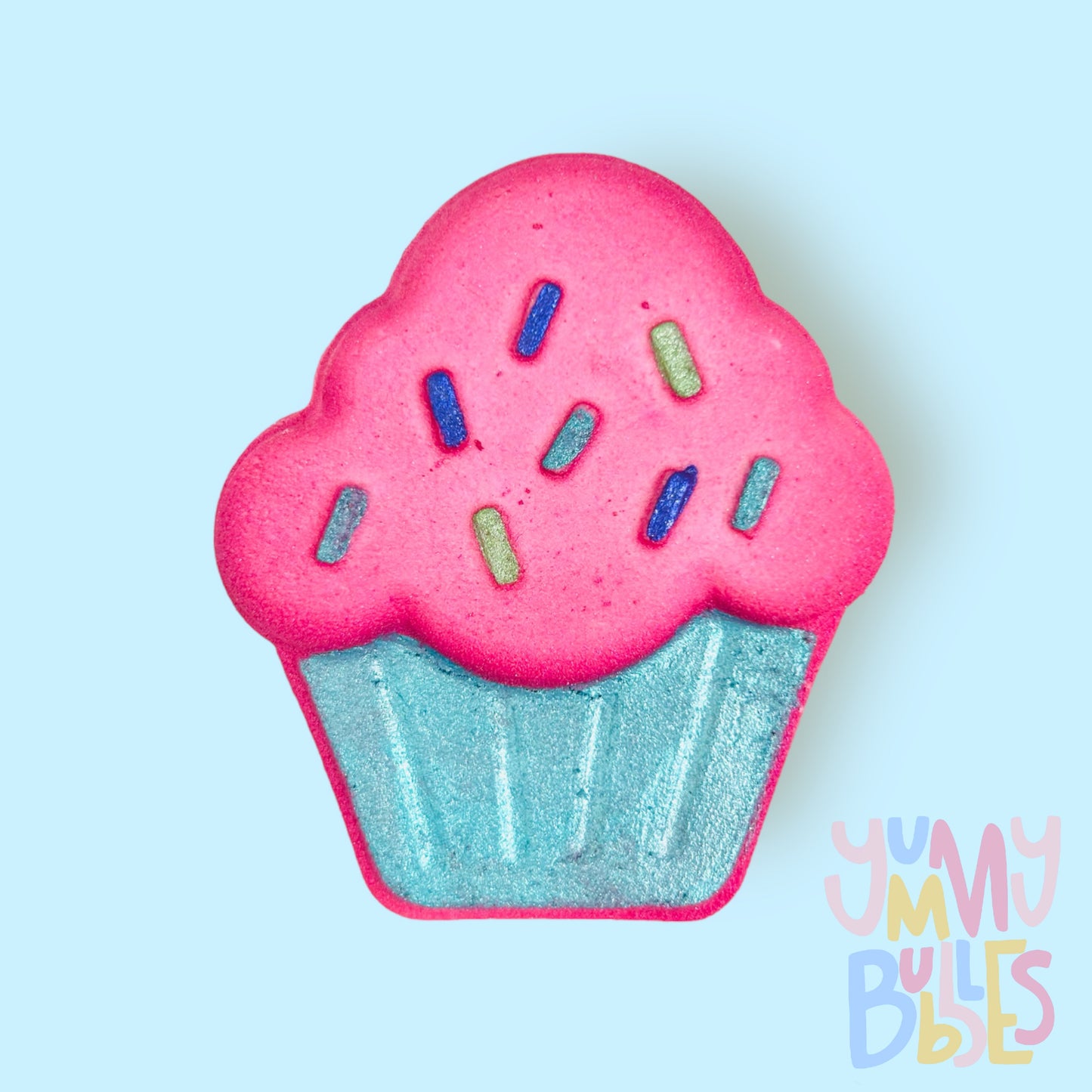 Pink cupcake shaped bath bomb painted with shades of blue and green