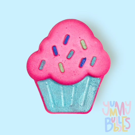 Pink cupcake shaped bath bomb painted with shades of blue and green