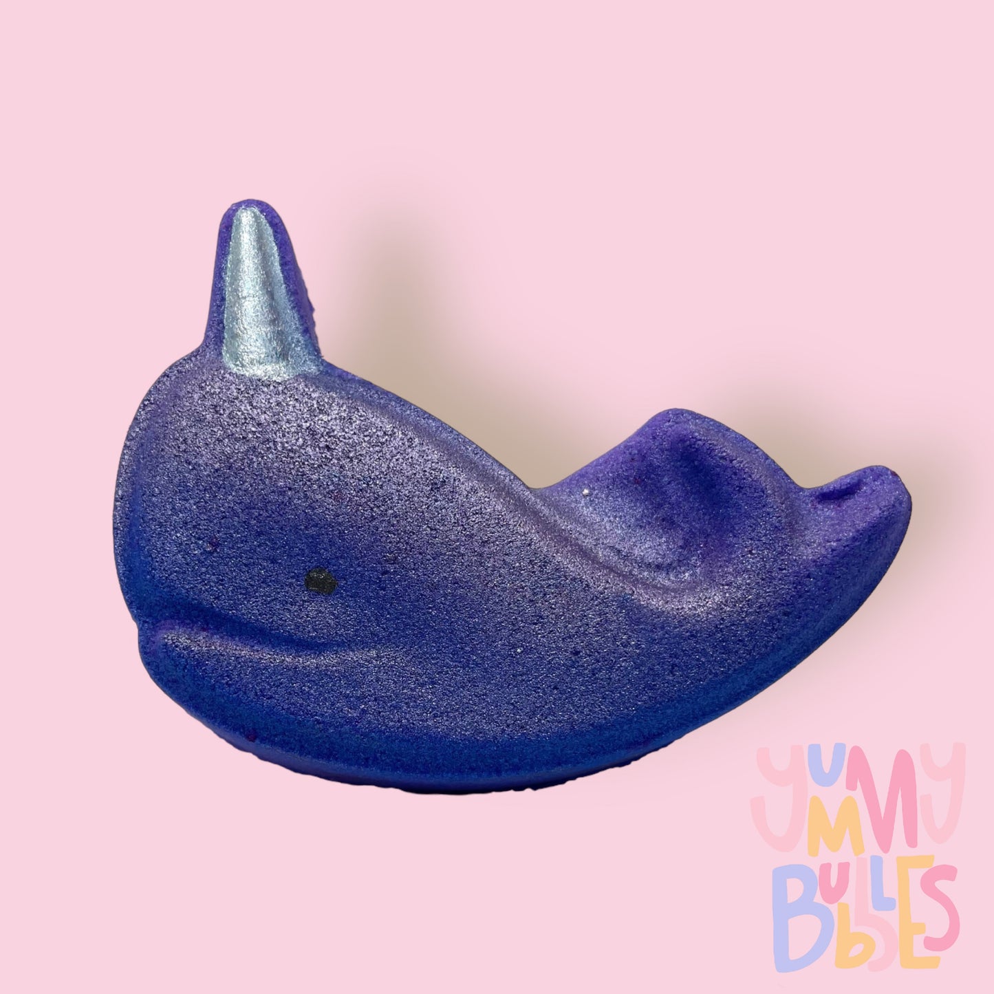Purple narwhal shaped bath bomb with a white painted horn