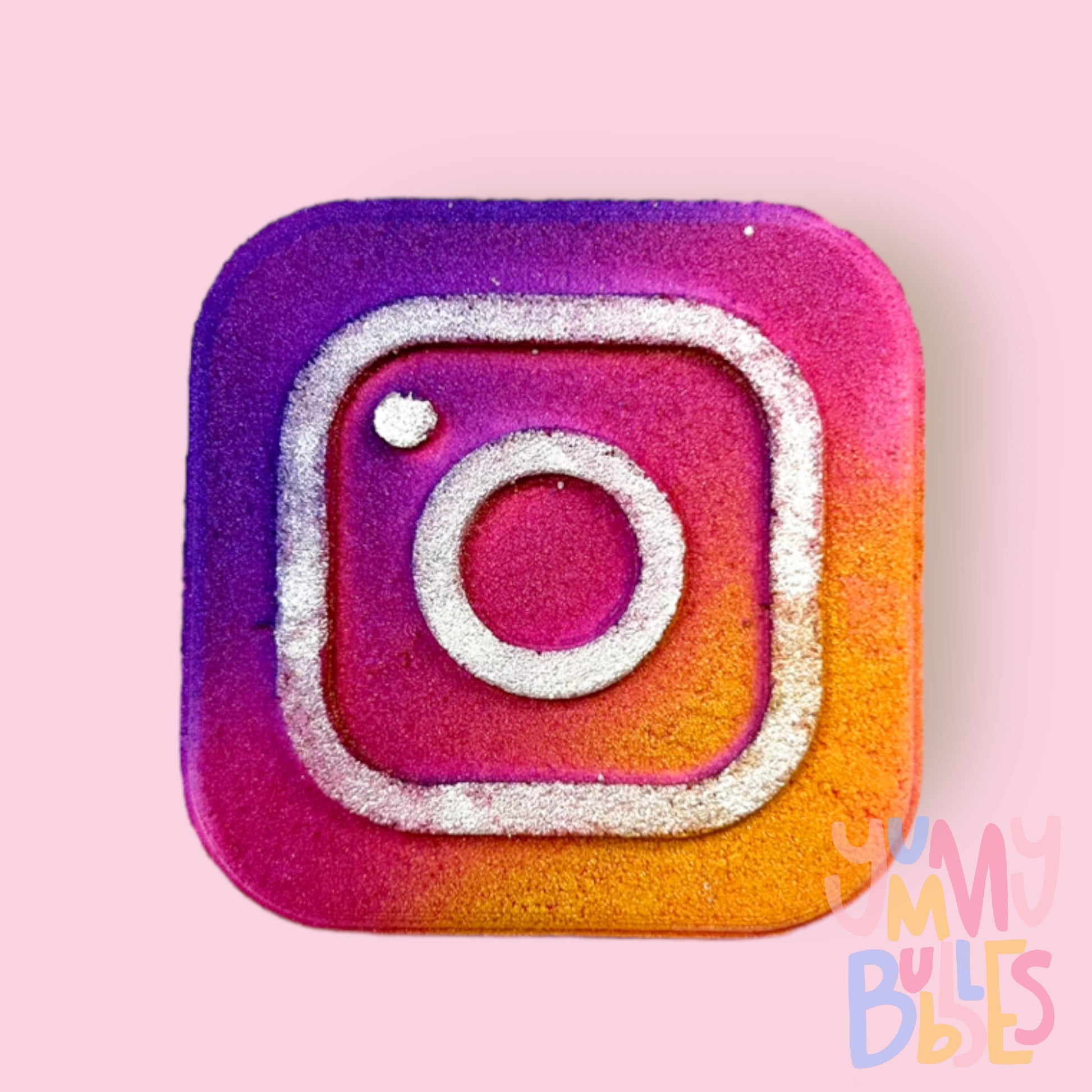 Square shaped bath bomb with the Instagram logo. Painted with purple, pink, orange, and white