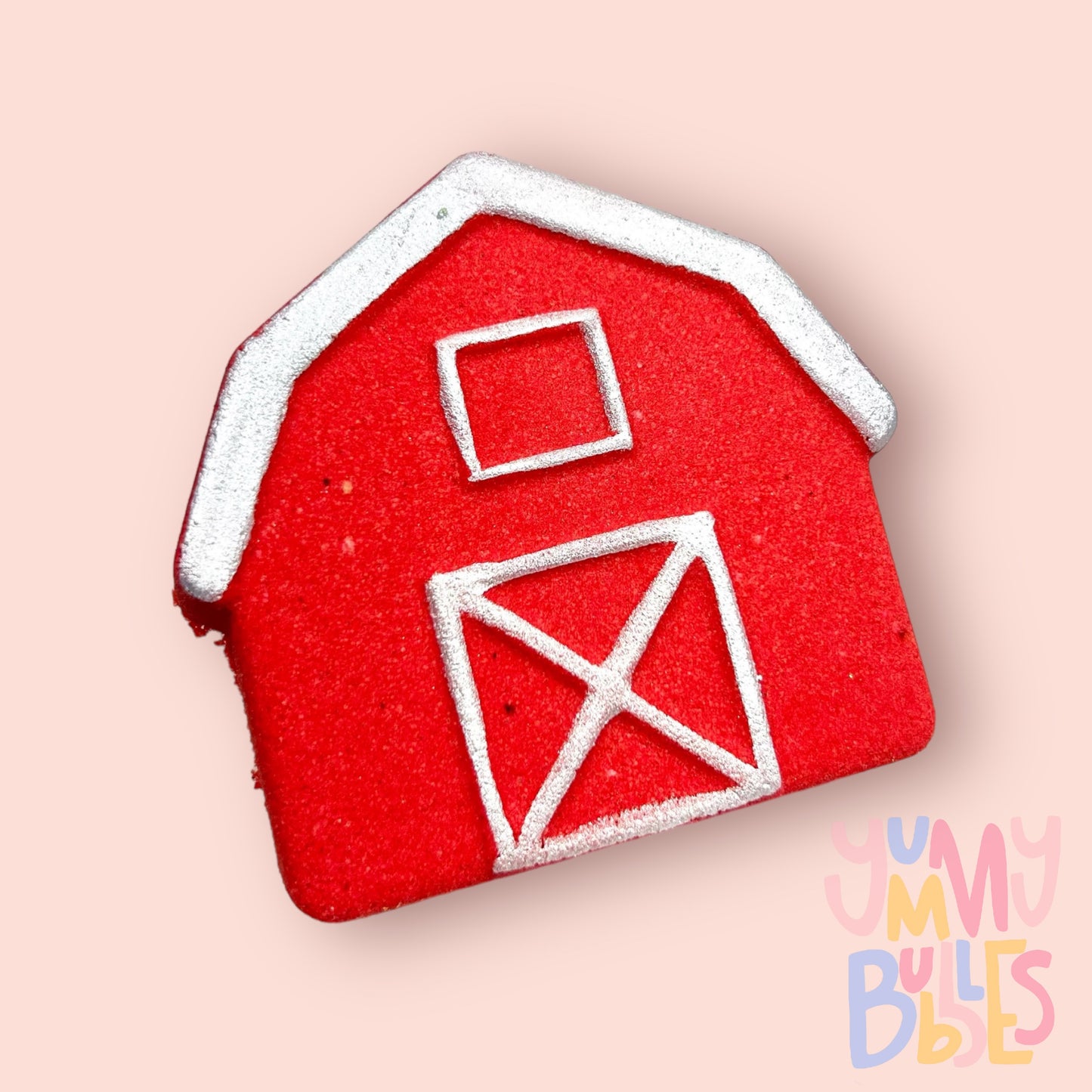 Red barn shaped bath bomb painted with white on details