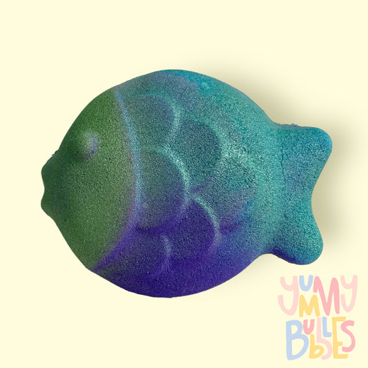 Fish shaped bath bomb with a blue, green, and purple airbrushed gradient painted on it