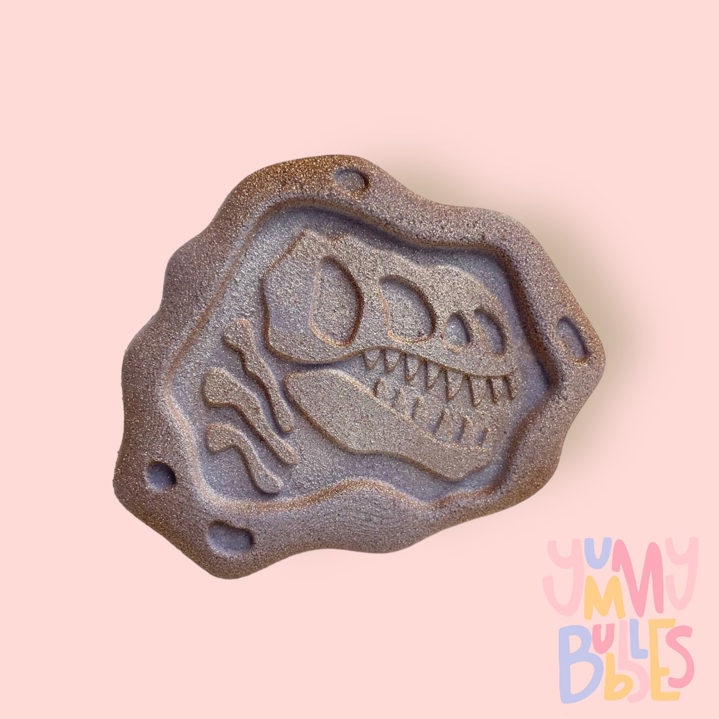 Brown fossil shaped bath bomb highlighted with white paint
