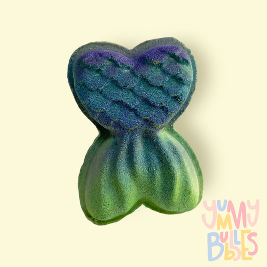 green mermaid tail shaped bath bomb highlighted with purple and teal