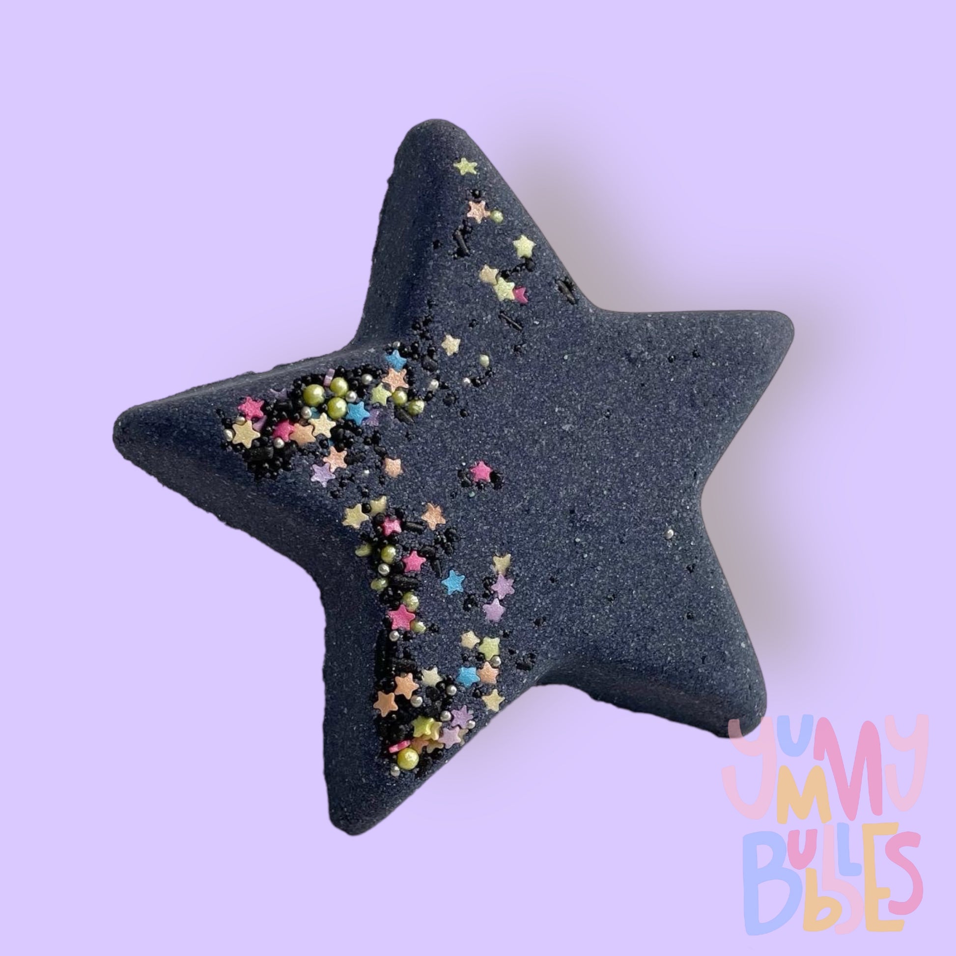 Black star shaped bath bomb with star and circular colored sprinkles