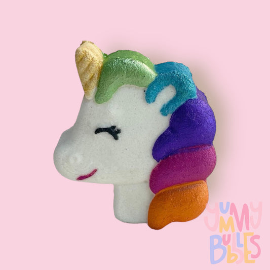 Unicorn head shaped bath bomb painted with gold, green, blue, purple, pink, orange, and black