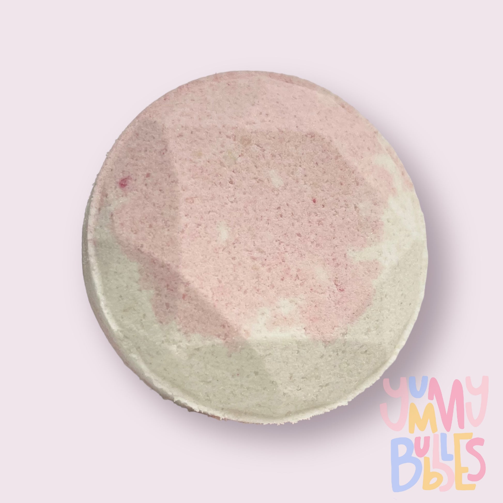 Circular shaped shower bomb colored with light pink and white