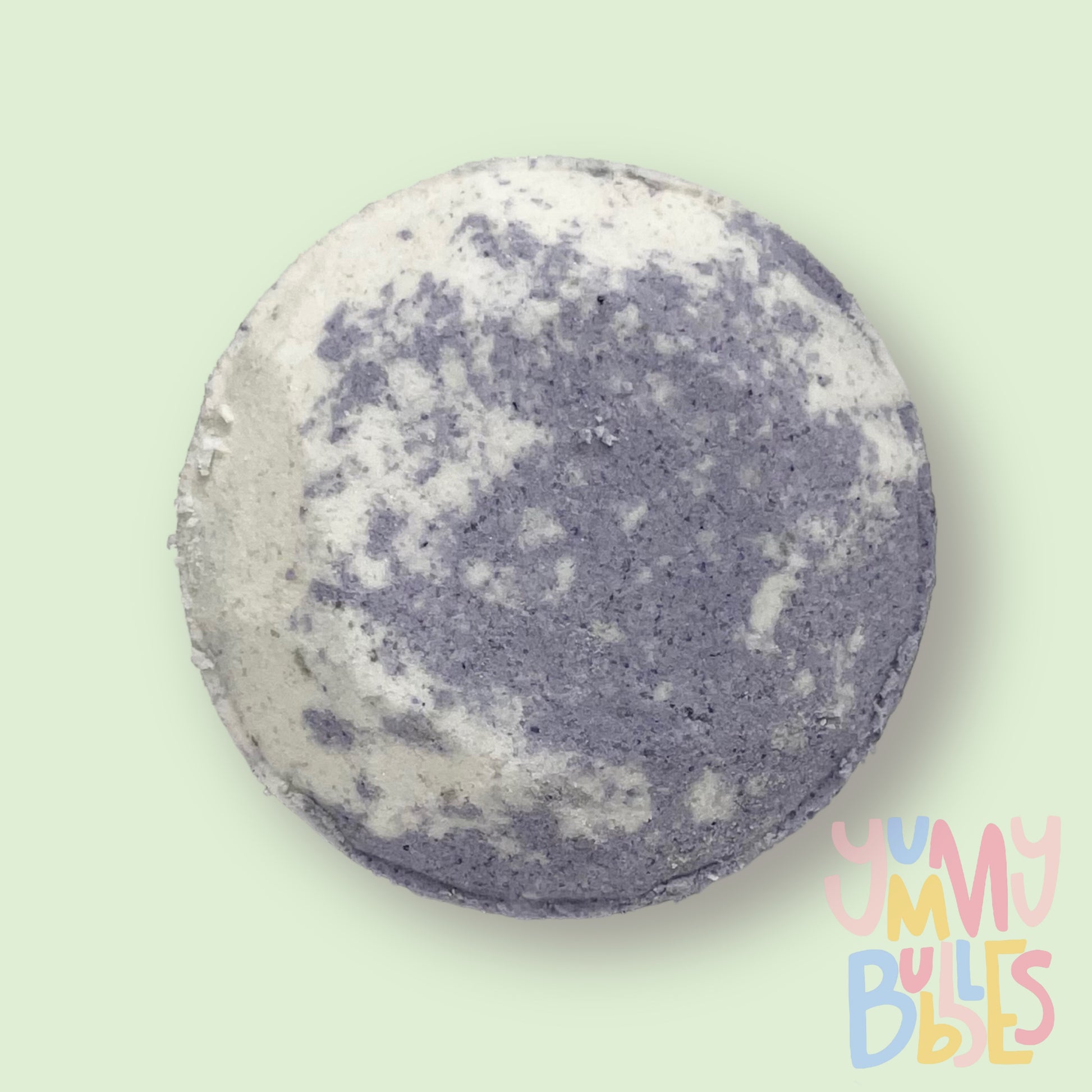 Circular shaped shower bomb colored with grey and white